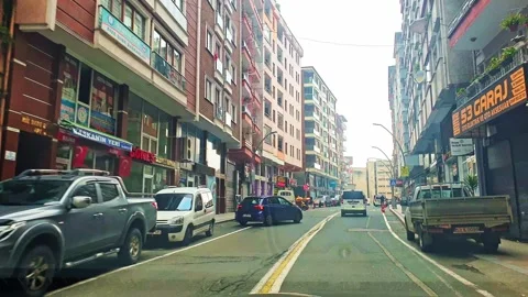 A white van driving down a street next to buildings Stock Footage 273016570