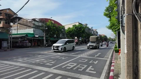 White Van Driving Through Urban Street Intersection in Bangkok Thailand Stock Footage 340182989