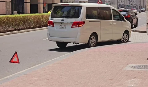 A white van parked a red hazard warning triangle on the road 스톡 동영상 311892148