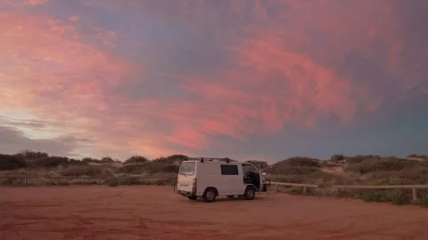 White Van at Sunset by Beach Dunes Under Pink Evening Sky Stock Footage 315666008