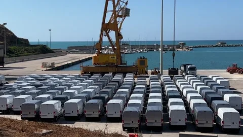 White vans ready to be loaded on ship at punta penna port dock Stock Footage 277514645