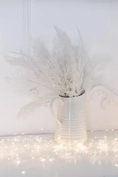 White vase with decorative spikelets on the table kitchen decor Stock Photos