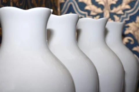 White vases are on the table.	 Stock Photos