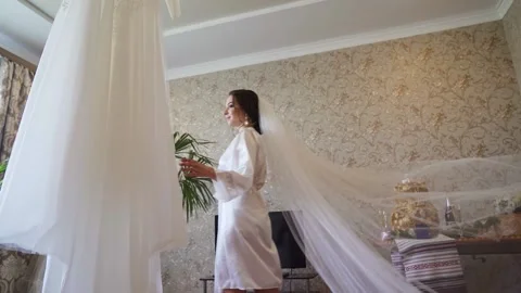 A white veil blowing in the wind. Couple standing near yacht. Slow motion Stock Footage 233524948
