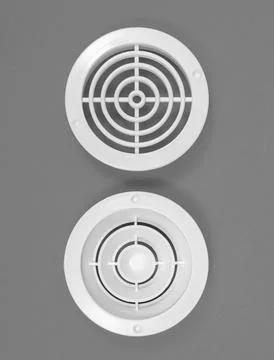 White ventilation grate on a gray background. Round shape. Top view. Stock Photos