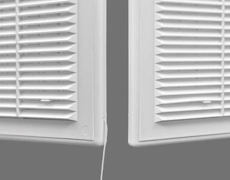 White ventilation grate on a gray background. Close-up. Material is plastic. Stock Photos