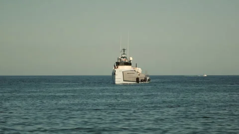 White vessel navigating open ocean water on a clear day. Concept of journey, Stock Footage 339808689