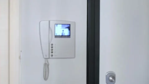 White Video Intercom that Turns on at the Ringing of the Doorbell Stock Footage 138933250