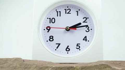 White vintage clock standing on stone table in house for display. Stock Footage 230114660