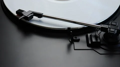 White vinyl record spinning on a turntable - close up of tonearm playing the LP Stock Footage 145883482