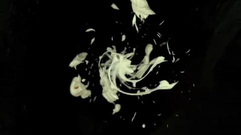 White viscous liquid explodes and spins revealing a metallic spider web cage Stock Footage 327577853