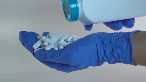 White vitamin tablets are poured into a hand. Stock Footage 295212592