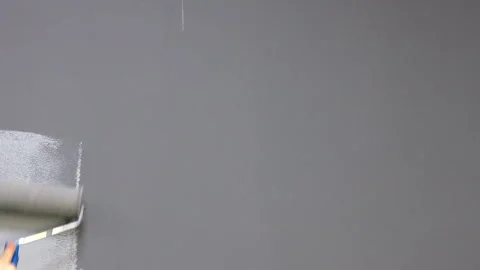 White Wall Being Painted Gray with Roller Stock Footage 295487917