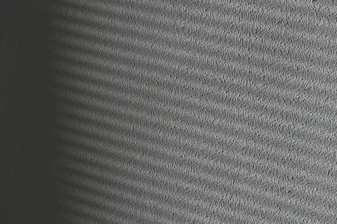 The white wall beneath rays of light throw the blinds Stock Photos