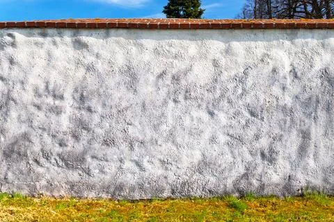 White wall, blue sky in the background Stock Photos