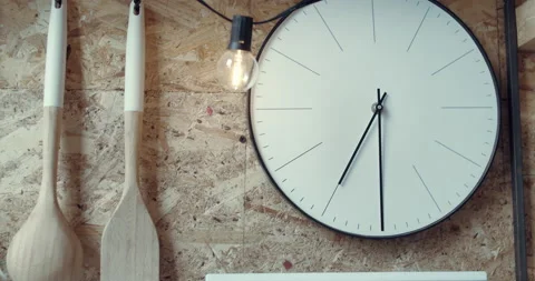 A white wall clock and a plaque with "Eat &amp; Drink" written on it. Video stock 135113526