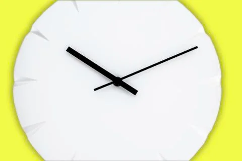 White wall clock with black clock hands hanging on the yellow wall. Minimalis Stock Photos