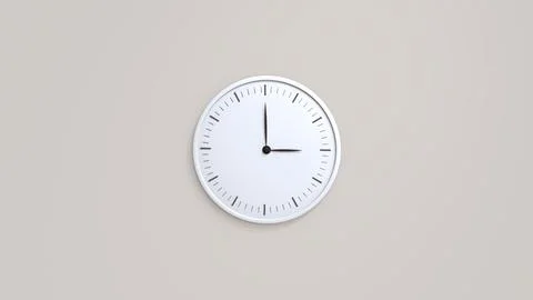 White wall clock with black clockwise hanging on the wall 스톡 사진