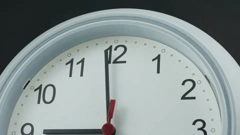 White wall clock with a clear dial showing black numbers. Stock Footage 230114550