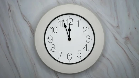 A White Wall Clock On Marble Background With A Time Of 12.00 Am Or Pm. A Vintage Video stock 220830379