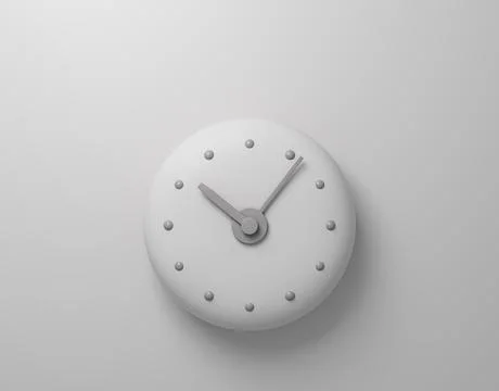 White wall clock with minimalistic design on a white wall. 写真素材