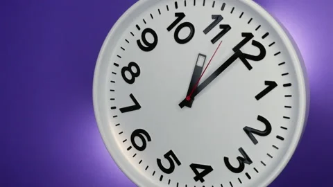 A White Wall Clock On Purple Background With A Time Of 11.00 Am Or Pm. A Black H Stock-Footage 233722941