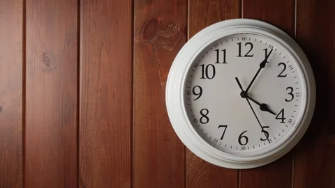 White wall clock on vertical wooden planks background showing time lapse movemen Stock Footage 345432747
