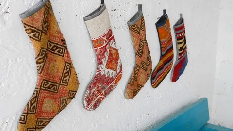 On a white wall in the courtyard hanging socks with Oriental ornaments Stock Footage 125021596