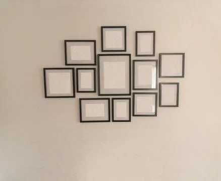 White Wall With Empty Picture Frames Stock Photos