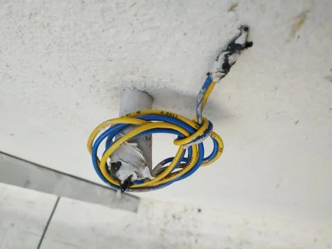 White Wall Fixed Small Plastic Pipe and Remaining Used Electrical Wires round Stock Photos