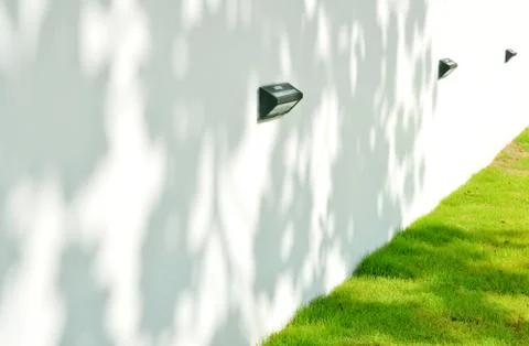 White wall with grass Stock Photos