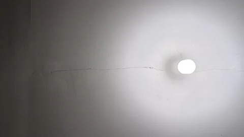 White Wall with Light Bulb On Stock Photos