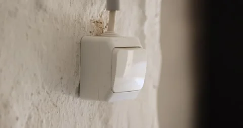 White wall light switch turning off garage door opener Stock Footage 346070085
