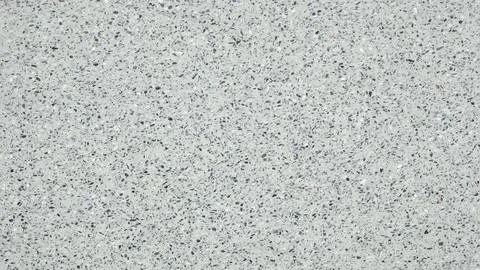 A white wall with a pattern of small dots. The wall is plain and unadorned. T Stock Photos