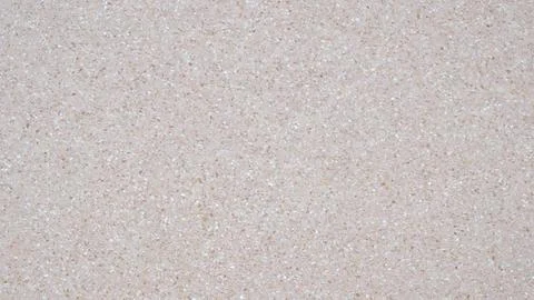 A white wall with a pattern of small dots. The wall is plain and unadorned. T Stock Photos