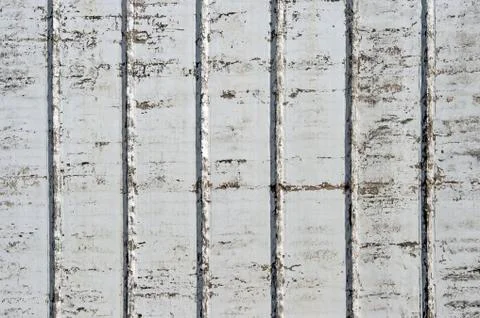 A white wall with a rough texture of a large industrial building with ribs an Stock Photos