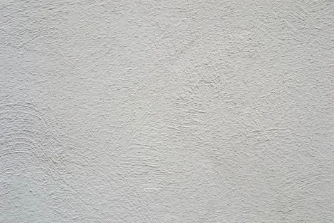 A white wall with a rough textured surface. Stock Photos