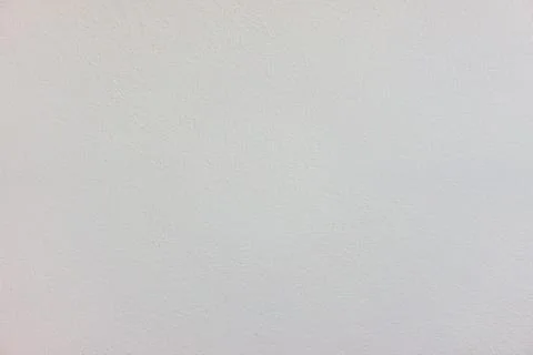 The white wall surface is rough in soft light. Stock Photos