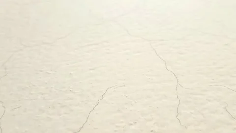 Off white wall texture with paint cracks sliding down, paper texture background Video stock 279434597