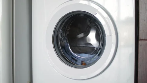 White washing machine cleaning clothes, spinning and rotating laundry inside Stock Footage 307208361