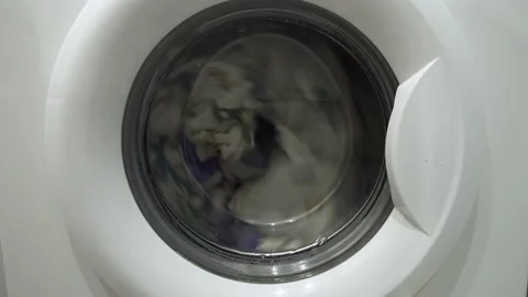 White washing machine washes dirty colorful clothes Stock-Footage 134021947