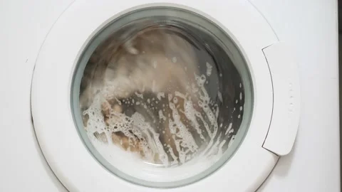 White washing machine washes dirty color clothes. Washing clothing in domestic Stock Footage 147366831