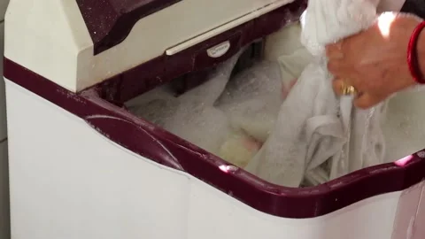 White washing machine washes dirty colorful clothes. Stock Footage 150287718