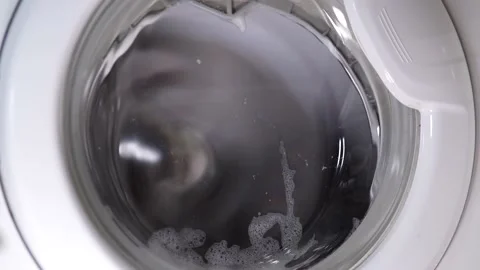 White washing machine washes dirty shoes. Stock Footage 158473487