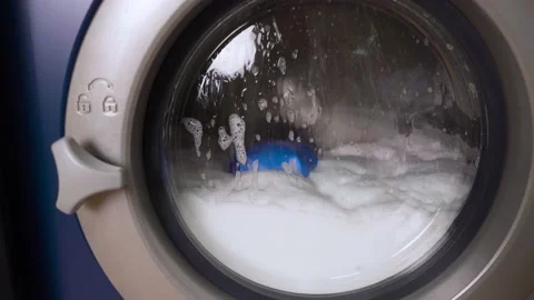 White washing machine washes dirty color clothes. Washing clothing in domestic Stock Footage 167263337