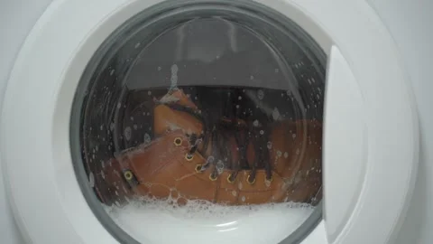 White washing machine washes dirty shoes. Stock Footage 332130371