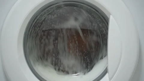 White washing machine washes dirty shoes. Stock Footage 332130509