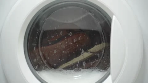 White washing machine washes dirty shoes. Stock Footage 332130600