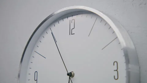 White watch with metal frame hangs on the wall Stock Footage 242951355