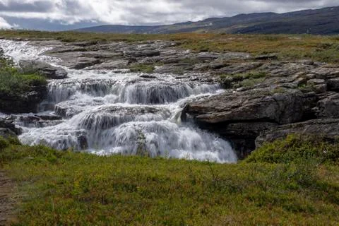 White water down a flat cliff in Norway. Stock Photos